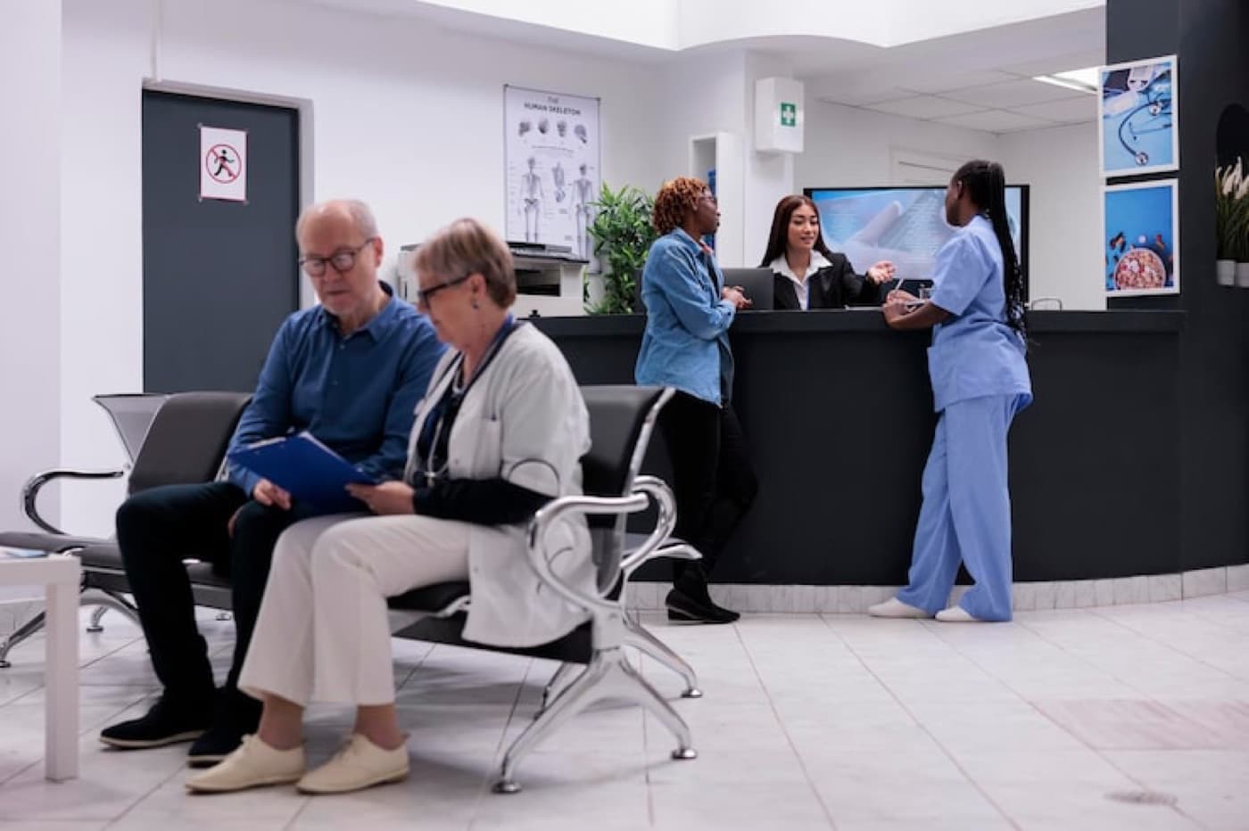 Patients and staff at a hospital reception desk