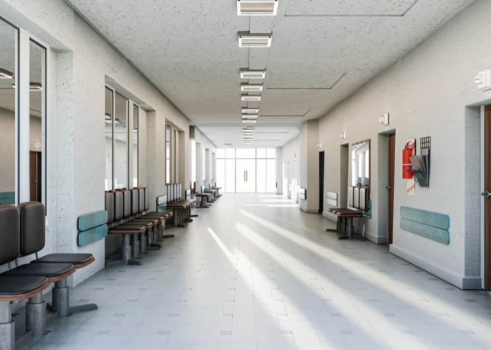 Bright hospital corridor with waiting chairs