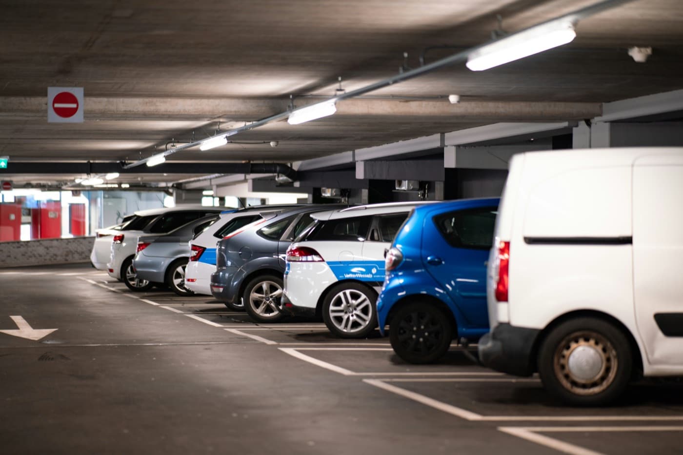 Car park with parked cars and a white van